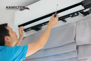 Professional technician performing AC Maintenance in Hamilton during spring tune-up