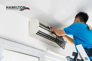 Air conditioner condenser showing signs that AC needs repair after Canadian winter